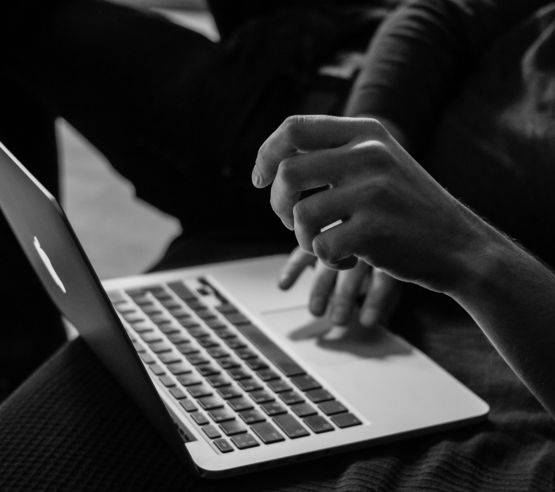grayscale-photo-of-person-using-mac-book.jpg grayscale photo of person using MacBook